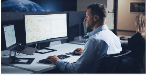 Engineer sitting at a computer and writing code