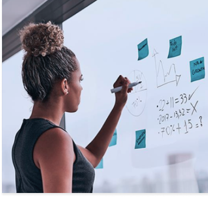 woman writing on a whiteboard showing technical planning
